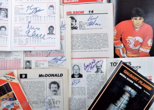 Calgary Flames Signed Media Guide Collection of 20 Featuring Al MacInnis, Lanny McDonald, Joe Mullen, Glenn Hall, Bob Johnson & Brett Hull