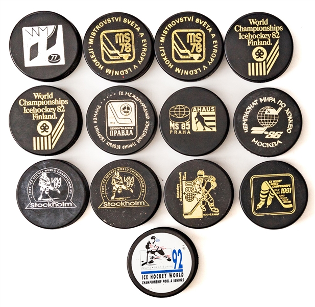 1977 to 1992 IIHF World Championship Puck Collection of 18 Plus Travel Suitcase From Team Canada Staff Member