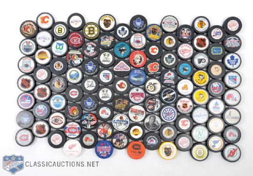 Collection of 100+ NHL Souvenir Pucks