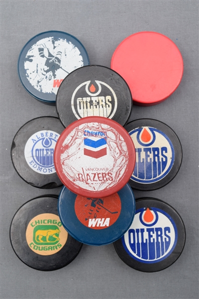 WHA Game Puck Collection of 9 with 1972-73 WHA Blue Biltrite Game Puck Caught at an Ottawa Nationals Game