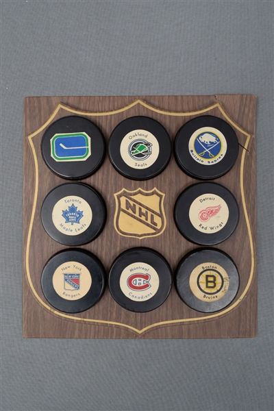 1972-75 NHL Biltrite Hockey Puck Collection of 8 with Display