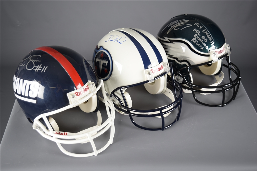 Quarterbacks Phil Simms (Giants), Michael Vick (Eagles) and Jake Locker (Titans) Signed Full-Size Riddell Helmets with COAs