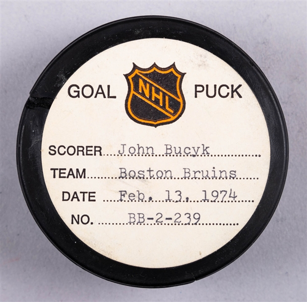 Johnny Bucyk’s Boston Bruins February 13th 1974 Goal Puck from the NHL Goal Puck Program - Season Goal #21 of 31 / Career Goal #456 of 556 - 3rd Goal of Hat Trick - Assisted by Bobby Orr