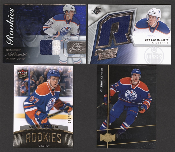 Connor McDavid Hockey Cards (7) Including 2015-16 SPx Rookie Fabric #SPXR-CM, 2015-16 Fleer Showcase Flair Materials #36 and 2015-16 Fleer Showcase Ultra Rookies #U1 (541/699)