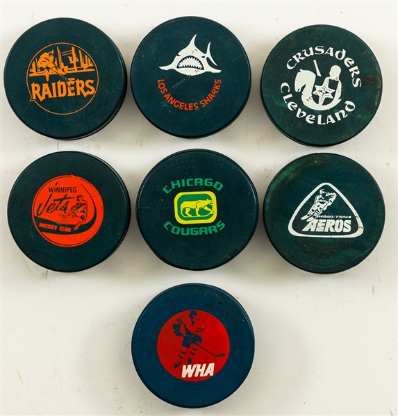 WHA 1972-73 Blue Biltrite Official Game Puck Collection of 7 from the Personal Collection of Norm Scully with His Signed LOA 