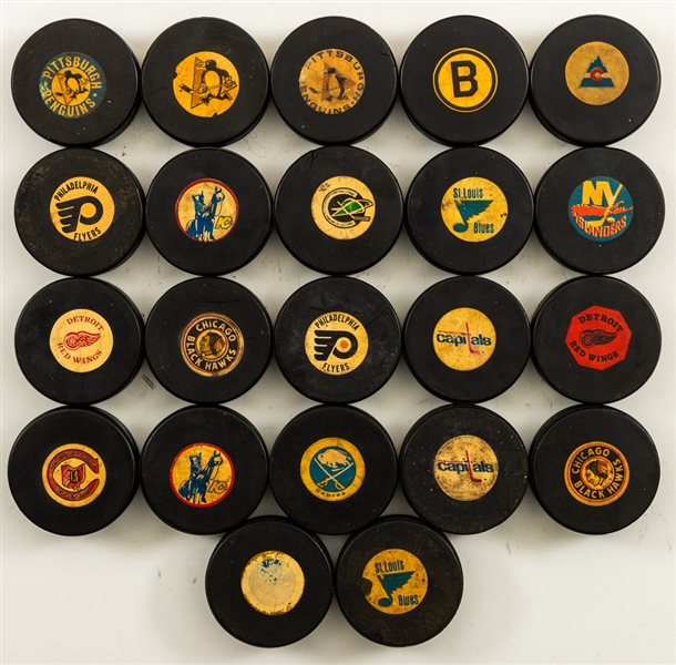 NHL 1969-77 Converse Game Puck Collection of 22 from the Personal Collection of Norm Scully with His Signed LOA 