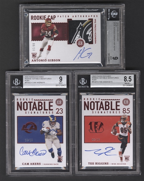 2020 Panini Encased Rookie Cap Ruby #128 Antonio Gibson RPA (08/10) Plus 2020 Rookie Notable Signatures #RNS-CA Cam Akers (15/15) and #RNS-TH Tee Higgins (08/15) - All Beckett Graded