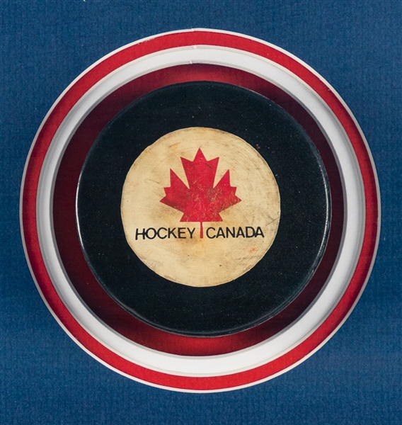 Superb 1972 Canada-Russia Series Game Puck and Team Canada Team-Signed Photo Framed Display (37” x 37”)