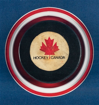 Superb 1972 Canada-Russia Series Game Puck and Team Canada Team-Signed Photo Framed Display (37” x 37”)