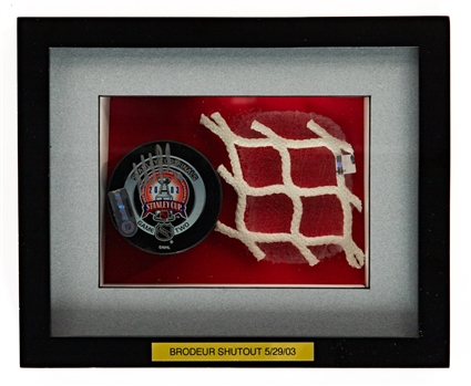 Martin Brodeurs May 29th 2003 Stanley Cup Finals Game #2 Signed 2nd Period Game-Used Puck from Shutout Game and 2003 SC Finals Piece of Net Framed Display with NHL and Steiner COAs